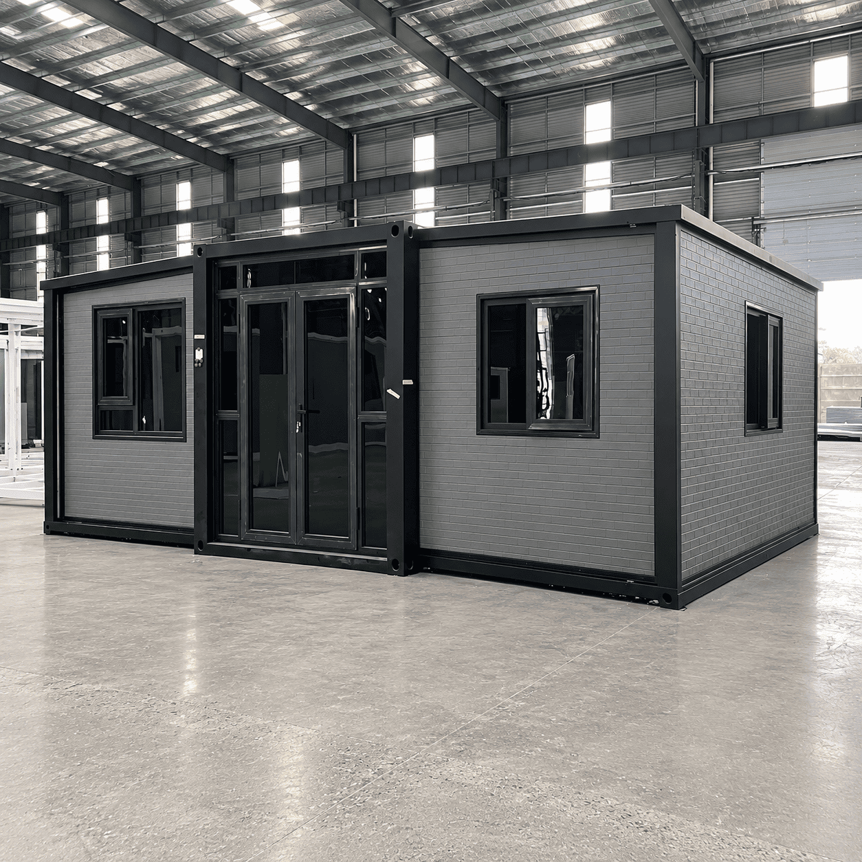 Casa Box 15 Fu&szlig; erweiterbares Containerhaus mit gebogener grauer Metallplatte
